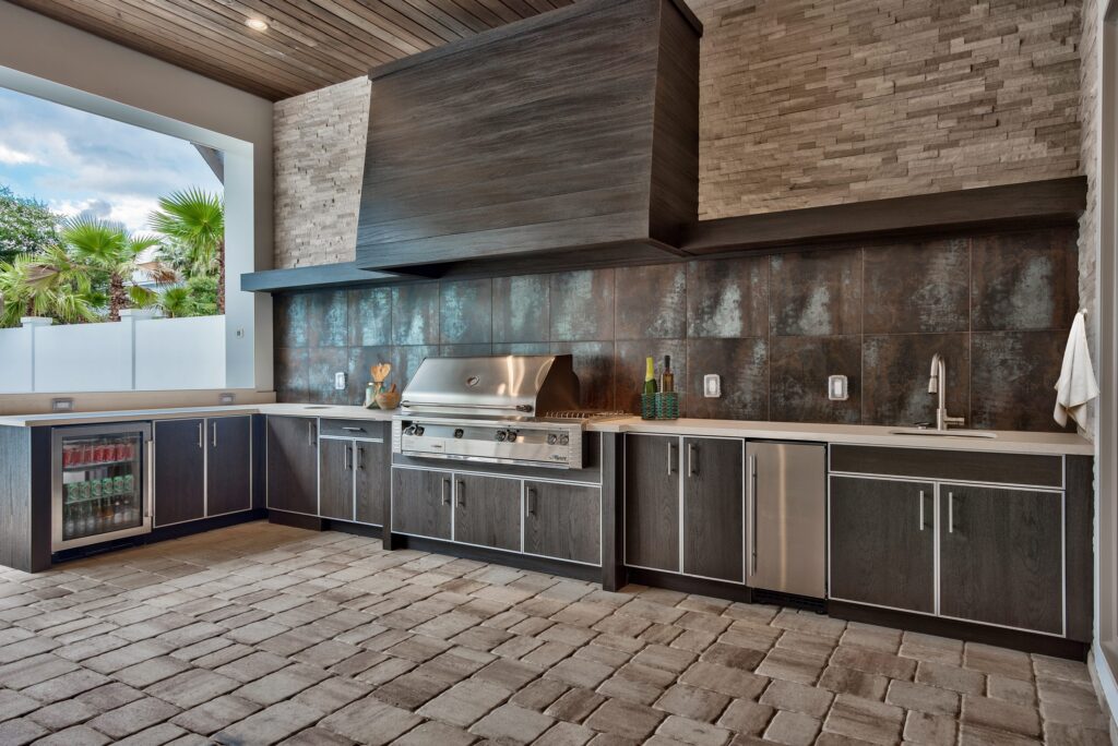 Custom finish work on a designed outdoor kitchen with hood