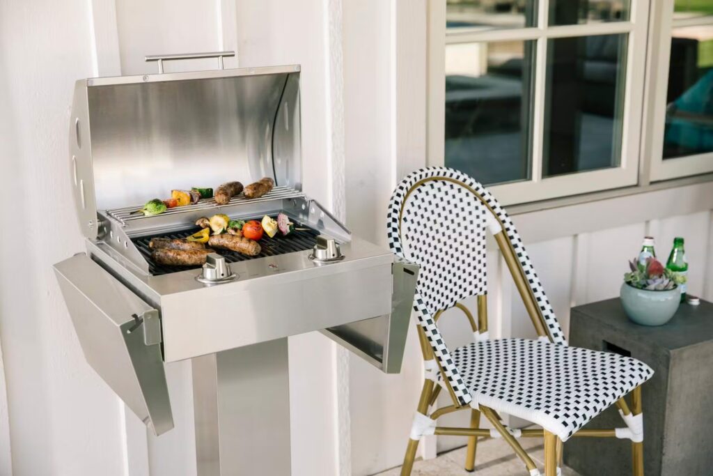 An electric grill cooking a full meal on a patio